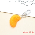Macro detail of a realistic orange pulp keychain with resin texture and silver metal clip - Orange Segments