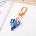Llavero de corazón de cristal azul y púrpura con ojo de la suerte y cierre dorado - Corazón de Tres Ojos