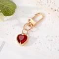 Detailed macro view of the gold-tone heart-shaped red crystal keychain on a stone base - 9# Dark Red Crystal Heart