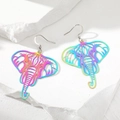 Detailed view of rainbow-plated elephant dangle earrings on a textured stone surface - Hollow Elephant