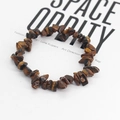 Macro shot of natural Tiger Eye stone bracelet with irregular polished mineral beads - Brown Stones