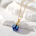 Detailed macro view of bohemian evil eye teardrop pendant with gold stainless steel chain - Dark Blue
