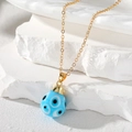 Vintage gold chain necklace with a teardrop blue evil eye glass pendant on white stone - Sky Blue