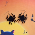 Detailed macro view of black acrylic spider earrings on Halloween moon background - Black Spider (Cross Hook)