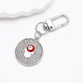 Macro view of silver Hamsa Hand and Evil Eye charm keychain with sparkling rhinestones - Silver Red Eye Hamsa Hand