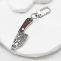 Mini vintage cleaver keychain with Damascus texture and silver lobster clasp on white stand - Mini Machete Shape / Karambit Knife