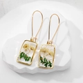 Detail of square resin earring featuring real yellow dried flowers and gold foil elements - Green Leaf Floral