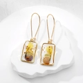 Handmade resin earrings with yellow and purple dried flowers and gold foil accents - Pansy