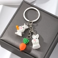Cute resin rabbit keychain with carrot pendant on minimalist grey jewelry box - Carrot Rabbit