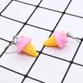 Detailed view of handmade pink resin ice cream cone earrings with star sprinkles - Pink Ice Cream