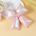 Close-up of a pink iridescent bow accessory with soft aurora metallic finish - Iridescent Pink