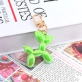 Metallic green balloon dog keychain with gold carabiner on elegant magazine backdrop - Metallic Green