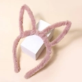 Détail d'un serre-tête oreilles de lapin en peluche rose poudré sur support blanc - Rose Lotus