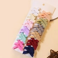 Detail of 12 handmade grosgrain ribbon bow hair clips displayed on a white cardboard card - Morandi Solid Color Set / Combination 3