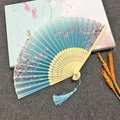 Elegant bamboo folding fan with light blue gradient fabric and cherry blossom prints - Blue Lady