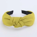 Detail of mustard yellow knotted headband featuring textured twill fabric and non-slip lining - Yellow