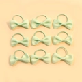Pack of nine mint green ribbed ribbon bow hair ties for girls on a soft beige background - Mint Green Single Knot Style