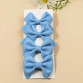 Set of four light blue waffle textured fabric hair bows for girls on a display card - Dark Blue