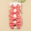 Set of four coral waffle-knit texture swallowtail bow hair clips on display card - Peach