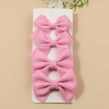 Set of four pink waffle texture bow hair clips on display card for girls and women - Pink