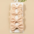 Set of four beige waffle-knit fabric bow hair clips displayed on a white card - Off-white