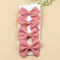 Set of 4 dusty pink waffle texture bow hair clips for girls on a display card - Bright Pink