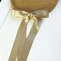 Elegant champagne gold satin bow hair clip with long ribbons and a smooth silk texture - Gold