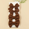Set of 4 dark brown waffle textured fabric bow hair clips displayed on a white card - Brown