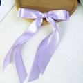 Elegant lilac satin hair bow clip with long ribbon streamers and a glossy silk finish - Light Purple