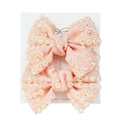 Pink ribbon bow hair clips for girls featuring sparkling rhinestones on display card - Snow Bud