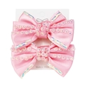 Set mit zwei rosa Satin-Haarspangen mit funkelnden irisierenden Strasssteinen auf Karte - Rosa
