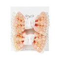 Pair of pink bow hair clips with pearls and rhinestones on a white display card - Nude