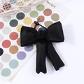 Elegant black satin bow hair accessory with long ribbons and premium elastic hair tie - Black