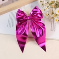 Elegant metallic purple bow hair clip with long ribbons in a decorative setting - Rose Red