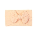 Soft apricot nylon baby headband featuring a large handmade bow for infants - Nude Pink