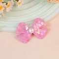 Pink sequin bow hair accessory with central faux pearl decoration on a pastel stand - Light Pink (#1)