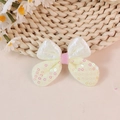 Sparkly sequin butterfly bow accessory with pearlescent wings and pink glitter center - Yellow