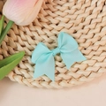 Mint green grosgrain ribbon bow with swallowtail design on a cozy woven mat - Mint Green (#7)