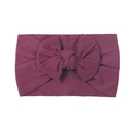 Soft nylon baby headband in burgundy red featuring a large knit bow for infants - Deep Purple