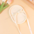 Elegante fiocco in raso bianco su spilla d'argento presentato su vassoio decorativo - Bianco Sporco