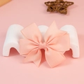 Light pink grosgrain ribbon bow accessory for hair and crafts on a decorative display - Flesh Pink