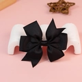 Black grosgrain ribbon bow decoration for hair accessories on a pink background - Black