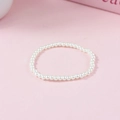 Elegant French vintage white pearl beaded bracelet on soft pink background - 4mm