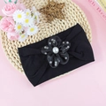 Elastic nylon baby headband featuring a black floral design with a white faux pearl center - Black