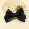 Classic large black satin bow hair accessory with soft glossy finish on straw mat - Black