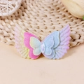 Close-up of glitter fabric angel wings and butterfly accessories with a central teardrop gem - Pink Blue Yellow Gradient Style (#1)