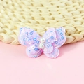 Macro detail of purple sequin butterfly accessory with white pearls for DIY sewing projects - Purple
