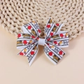 Handmade school bow hair clip with red apples and yellow school bus patterns - White With School Bus Print