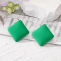 Close-up of green matte square stud earrings featuring a minimalist geometric resin design - Grass Green