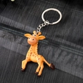Cute yellow giraffe cartoon keychain with brown spots and silver metal ring accessory - Giraffe